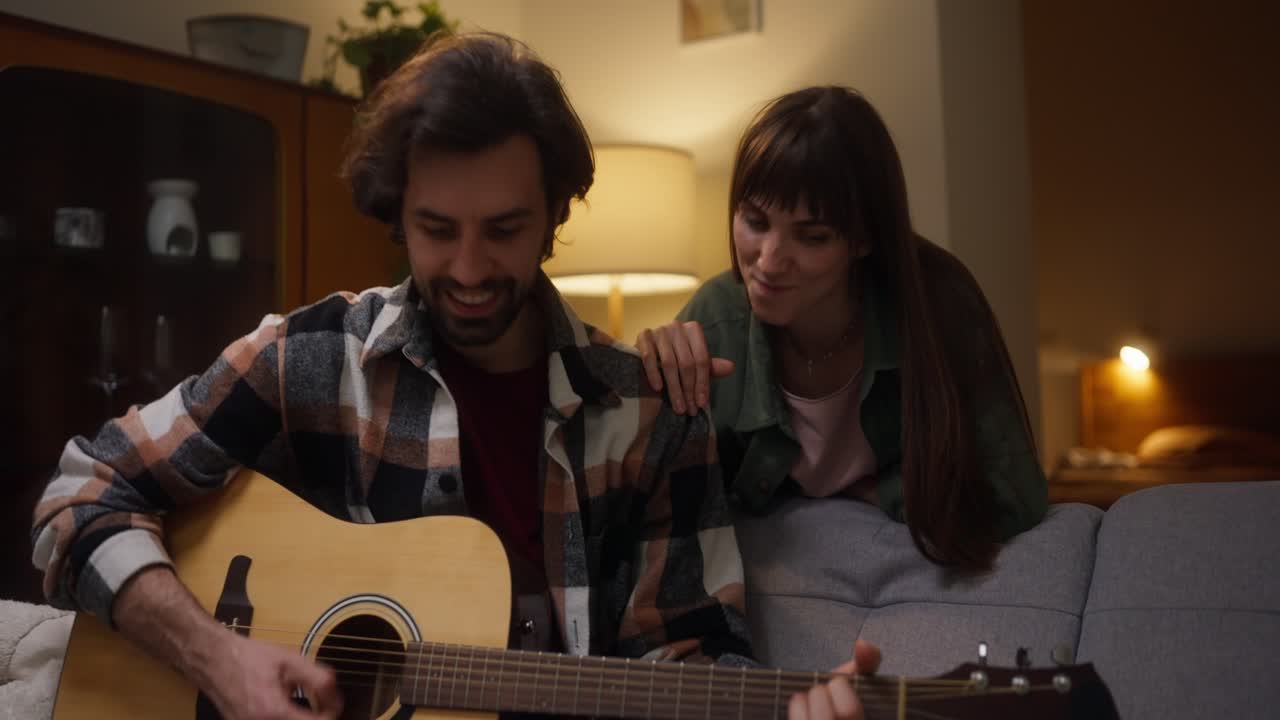 Couple enjoying music with acoustic guitar