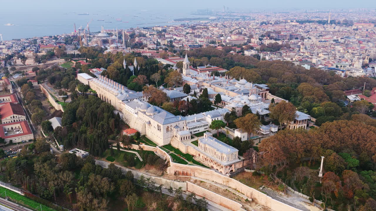 A wide aerial of Topkapı Palace and surrounding greenery, overlooking the city and Marmara Sea stretching toward the horizon