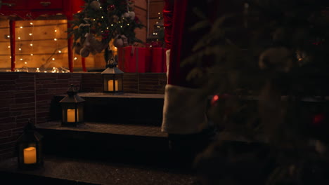 close-up of santa claus's feet walking down the steps of the house on christmas eve