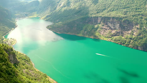 Aerial-View-Of-Geiranger-Fjord-SUrrounded-With-Mountains-On-A-Sunny-Day-In-Sunnmore,-Møre-og-Romsdal,-Norway