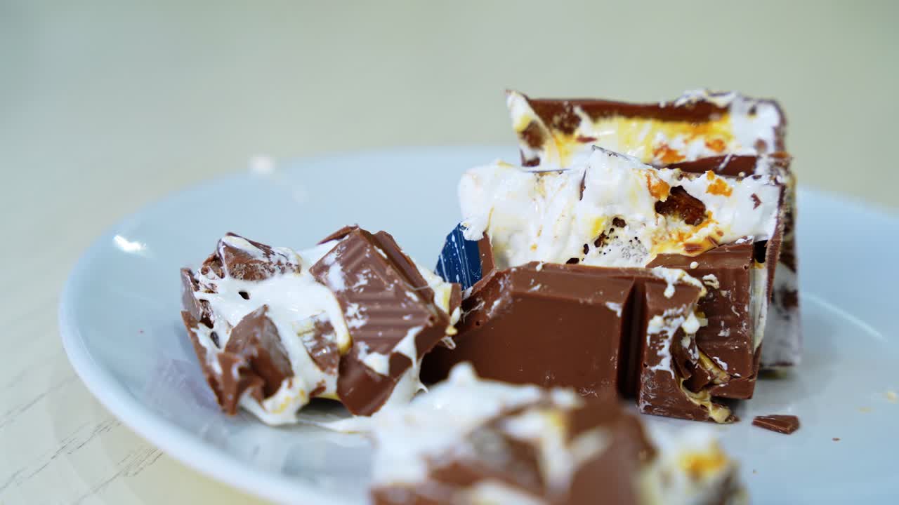 Tempting close-up of gooey chocolate and marshmallow candy, ideal for food ads, dessert visuals, or cooking promos.