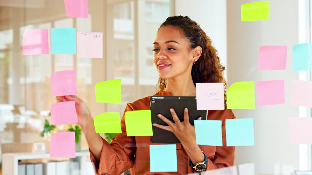 Happy female designer planning ideas on a glass