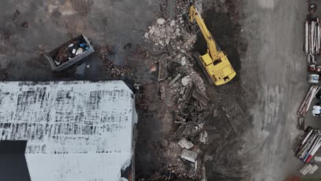 direct aerial of a small street, tracking outward between boat storage buildings