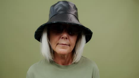 stylish woman in bucket hat and sunglasses