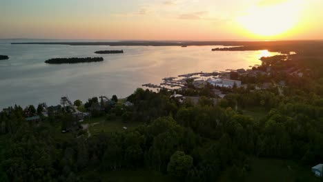 Aerial-Hessel,-Michigan-sunset-pan-ascent