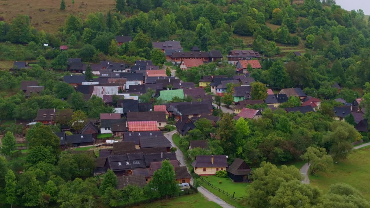 Drone shot of Vlkolinec village surrounded by vibrant autumn foliage