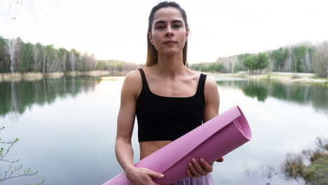 woman with mat in the forest