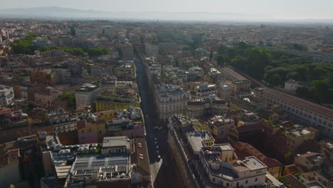 Streets-and-buildings-in-historic-city-centre-in-morning.-Aerial-panoramic-view-of-metropolis.-Rome,-Italy