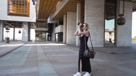 woman taking photo outside of a building