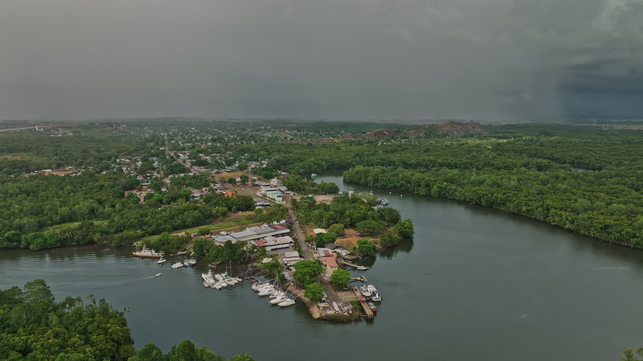 Pedregal Panama Aerial v2 pan shot capturing landscape of platanal river and port town with dark clouds in the sky and storm approaching during raining season - Shot with Mavic 3 Cine - April 2022