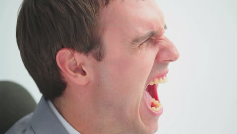 man screaming while sitting on a chair