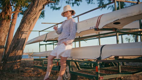 travel model enjoying evening on lake weekend. smiling happy girl leaning boat