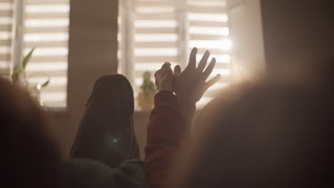 couple holding hands by the window