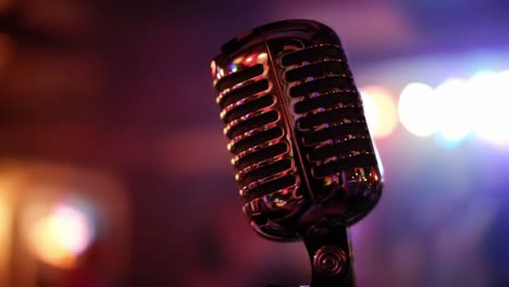 a vintage microphone captured in two different stages, highlighting its classic design against a vibrant, colorful background of soft bokeh lights