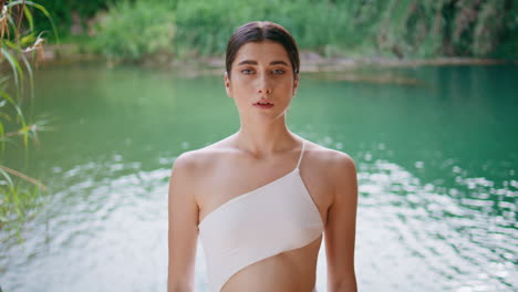 serene model posing water nature wearing swimsuit closeup. lady alone at lake