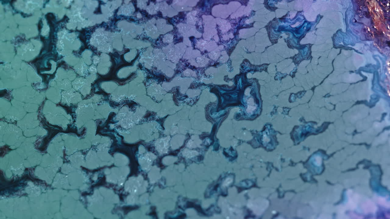 Colorful liquid mixture blending and forming abstract patterns in a macro shot