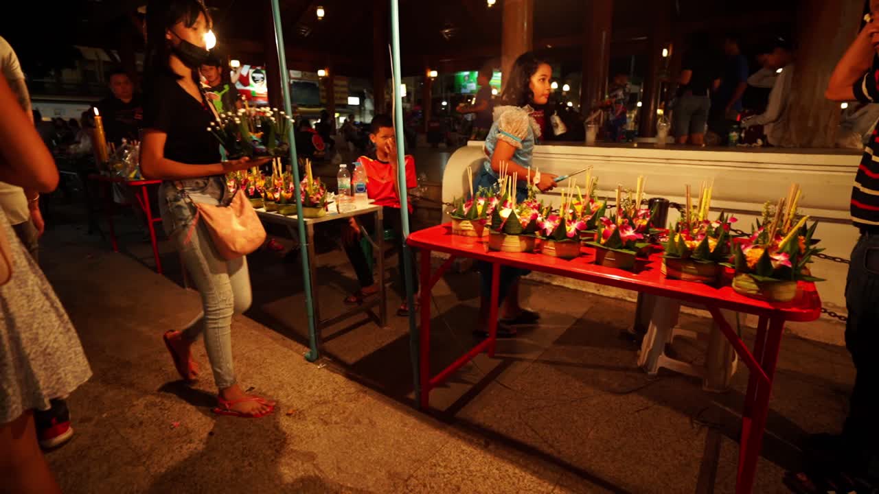 Counters with Decorative Loy Krathong rafts laid out ready to sell during the Loi Krathong festival in Chang Mai, Thailand. Krathongs made out of banana leaves and flowers on the counter for selling