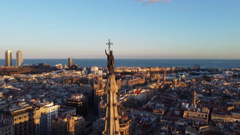 cathedral of barcelona in middle of the city at sunset. aerial dolly out