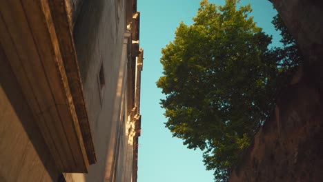 Lisbon-Alfama-ancient-church-convent-side-facade-under-the-trees-at-sunrise-4K