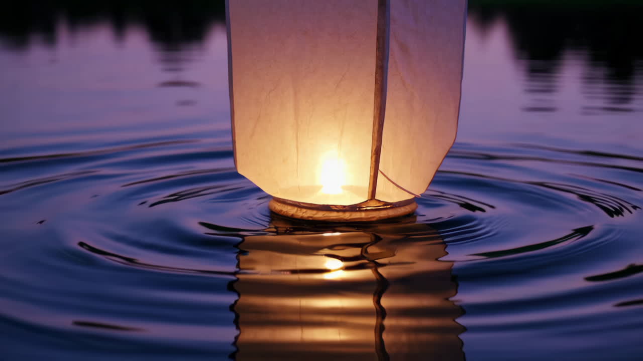 Sky Lantern Floating on Water at Sunset