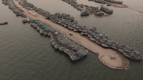 aerial view of fishing boats moored along jetty at ibrahim hyderi in karachi