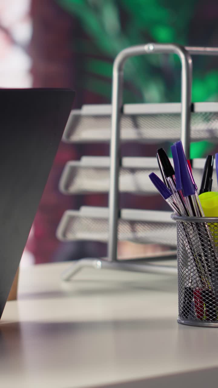 Vertical Video High end home office in a trendy loft apartment with an empty desk