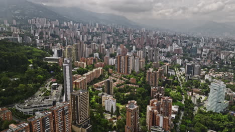 Medellin-Colombia-Aerial-v9-flyover-Castropol-capturing-hillside-cityscape-across-Lalinde,-El-Poblado-and-Las-Lomas-I,-mix-of-commercial-and-residential-areas---Shot-with-Mavic-3-Cine---November-2022