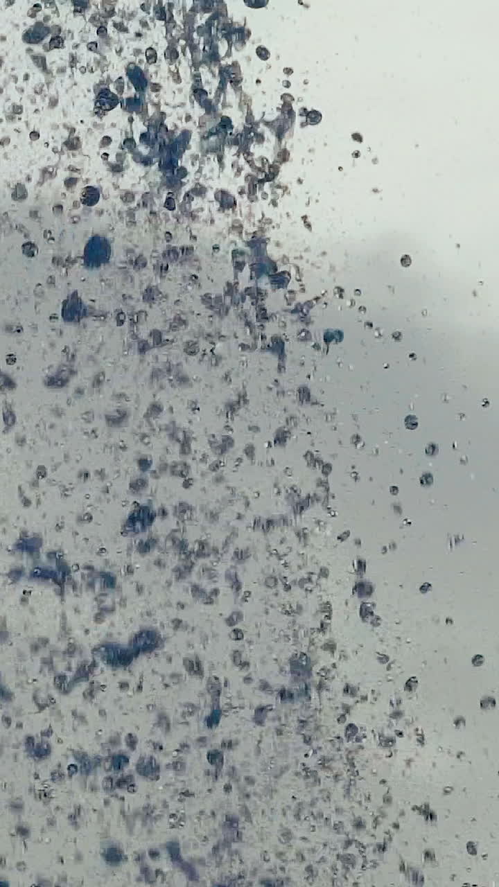 Water droplets. Streams of fountain close-up. Slow motion Vertical video