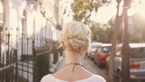 beautiful blonde walking through city