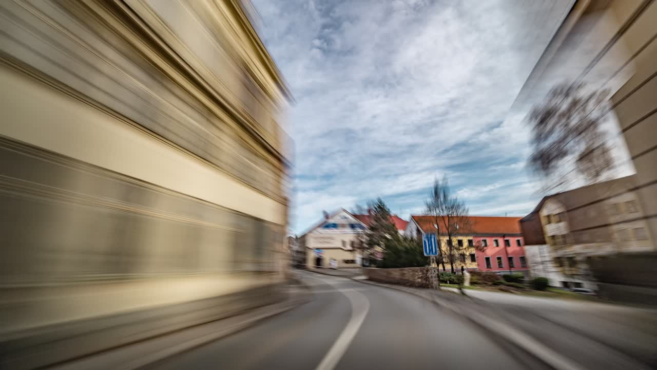 A hyperlapse video. Driving on freeway. Speeded up video. The sky, clouds, trees on the sides of the road, fields, vegetation, passing cars are just a blur. Cars racing past.