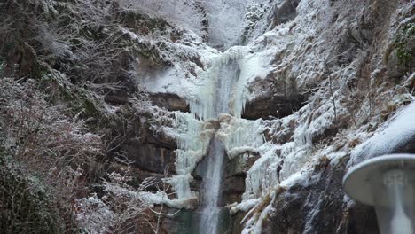 clip of a frozen waterfall filmed in europe in austria from a town called hallstatt