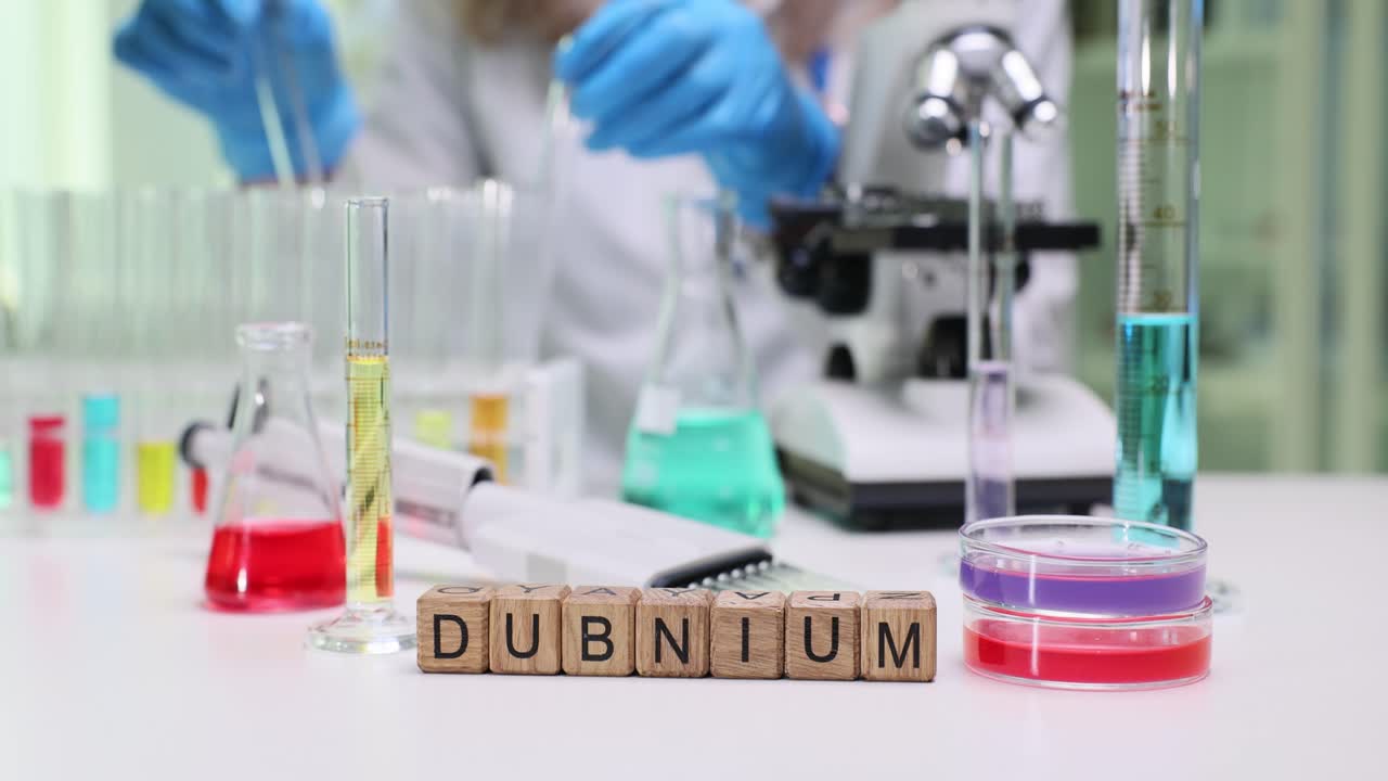 Dubnium Element Blocks in a Science Laboratory with Scientific Equipment