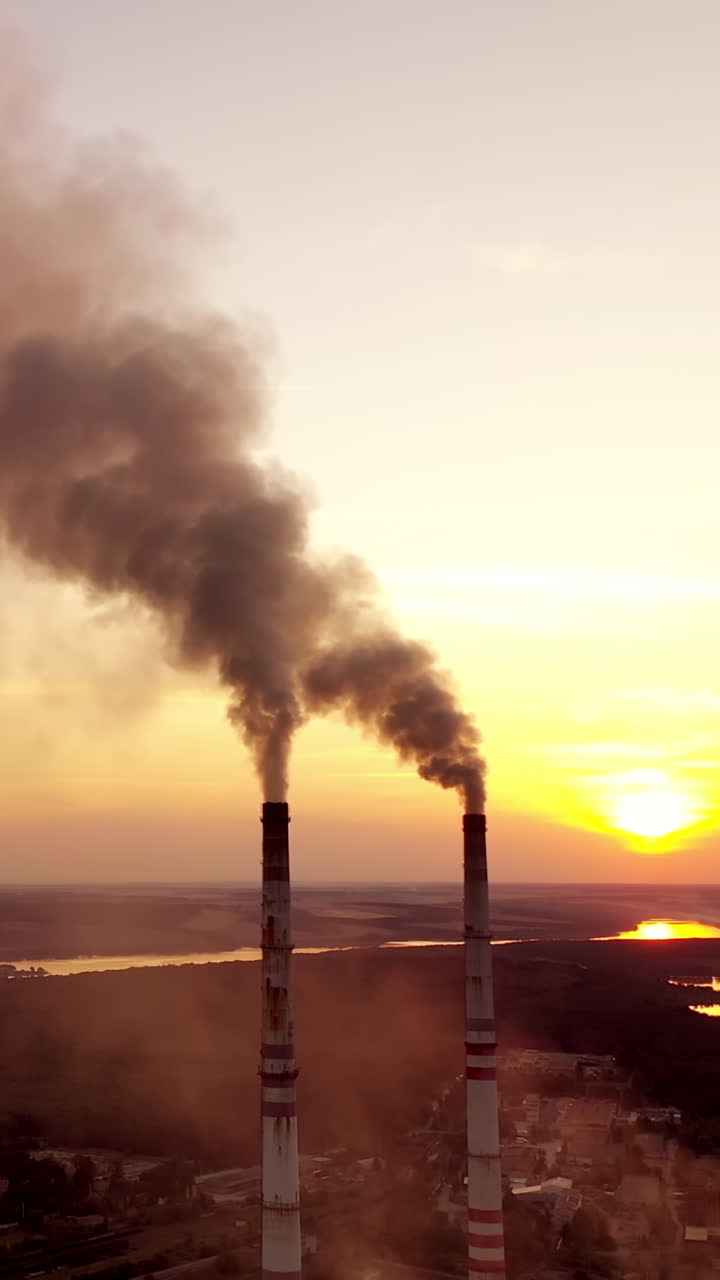 Smoking pipes of factory. Polluting the atmosphere with smoke Vertical video