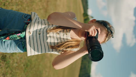 young girl photographer shooting landscape young photographer shooting landscape on beautifull green hillway taking pictures of nature girl filling the portfolio with amazing photos spending leisure time outdoor slow motion