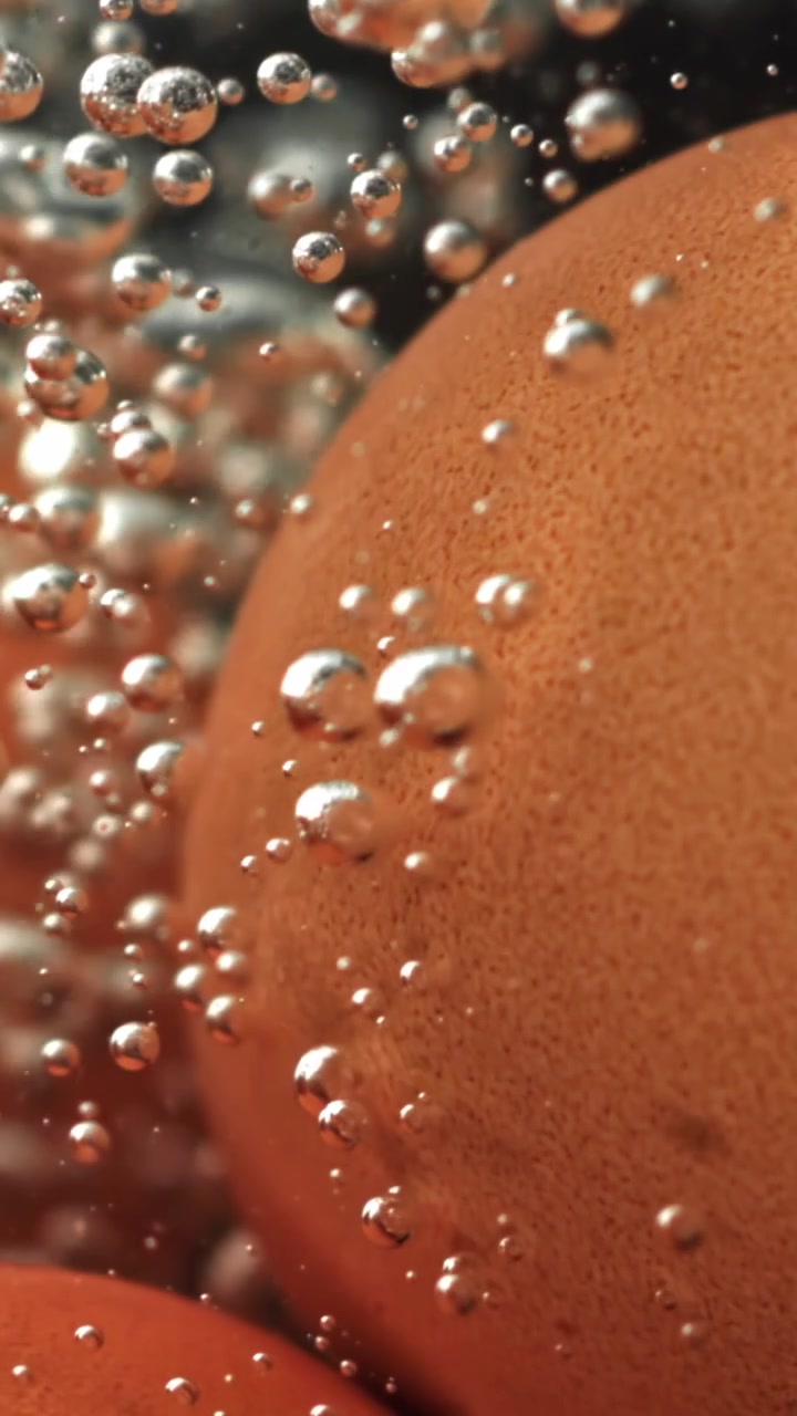 Close-up of an Egg Boiling in Water with Rising Bubbles