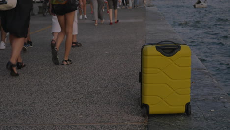 suitcase on wheels stands on sea coast in city of thessaloniki greece