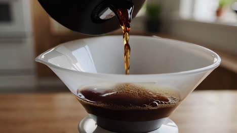 pouring coffee into a pour-over dripper