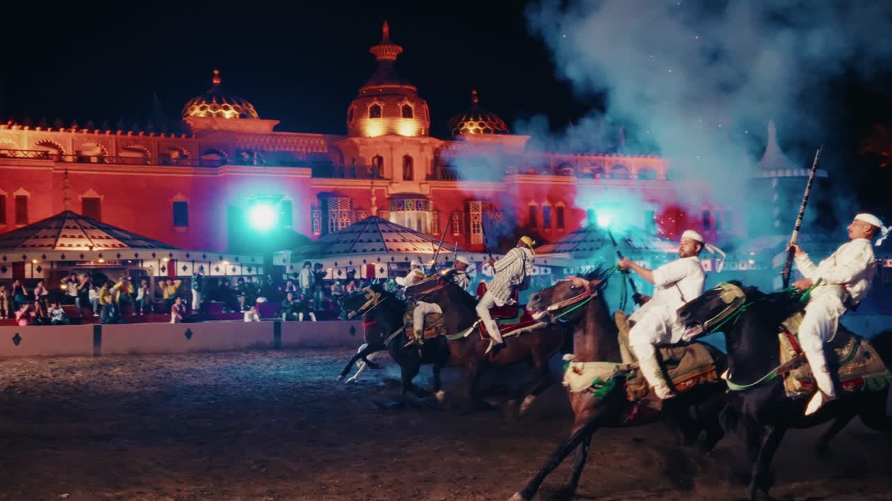 Display of folklore show in Chez Ali, Marrakesh, Morocco. Professional equestrians riding horses and firing gunpowder for entertainment.
