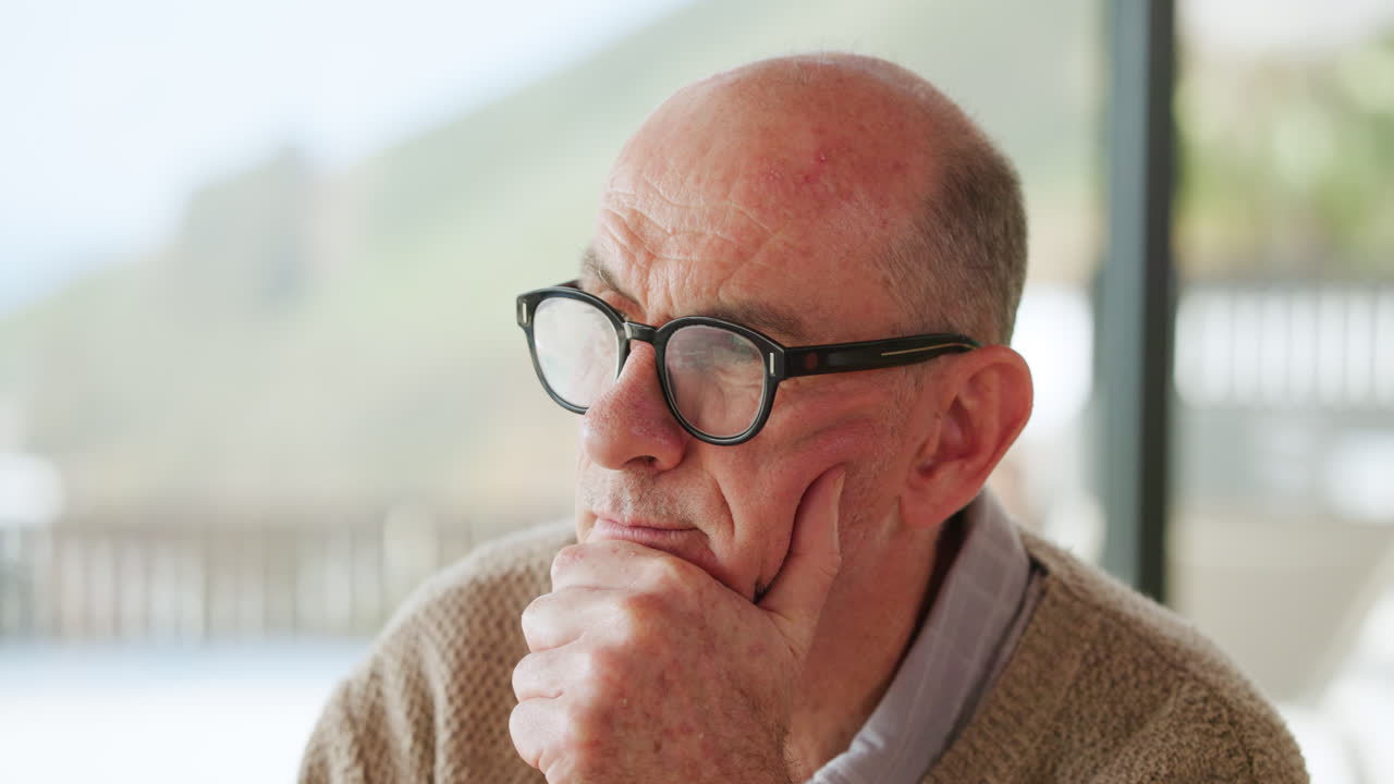 Thoughtful Senior Man with Glasses Looking Away