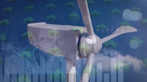 animation of graphs, shapes and moving wind turbine over caucasian man working in office