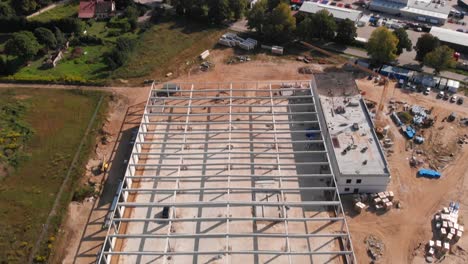 The-construction-of-a-hall-with-a-concrete-skeleton-is-underway,-and-there-is-a-beautiful-view-of-the-surrounding-landscape