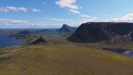 a breathtaking aerial view of a mountain range with vast open plains and a clear blue sky, capturing natural beauty and tranquility