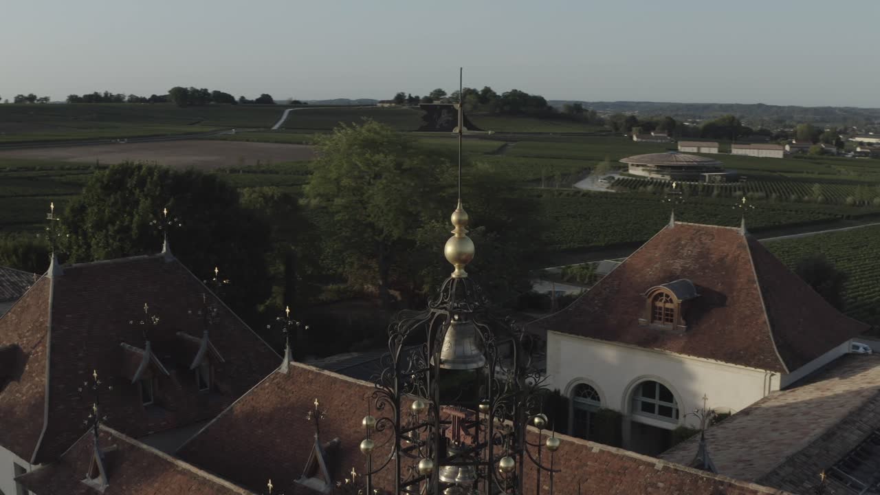 Drone orbiting around bell tower at Château Angelus winery, France. Aerial