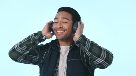 Happy-asian-man,-headphones-and-dancing-to-music