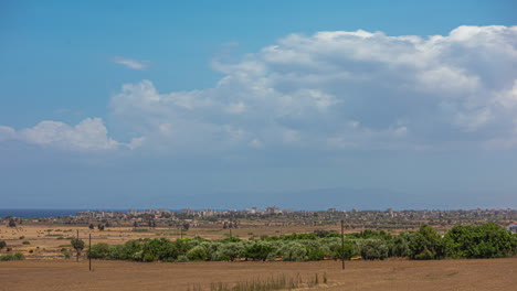 timelapse of big clouds moving on a windy day over a yellow field