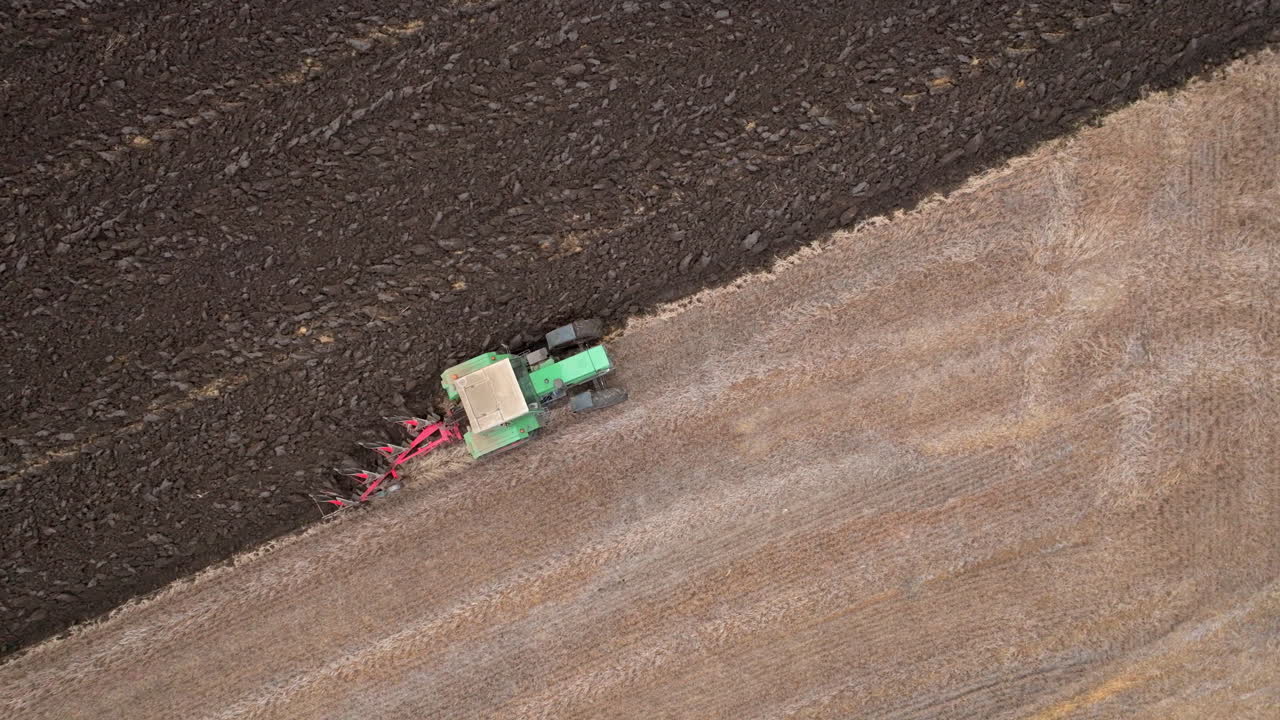 Tractor plowing a field from an aerial view