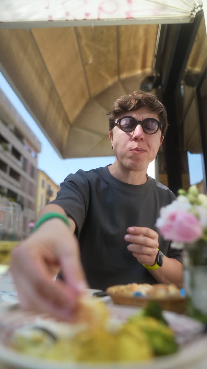 Man Eating Lunch Outdoors at a Cafe