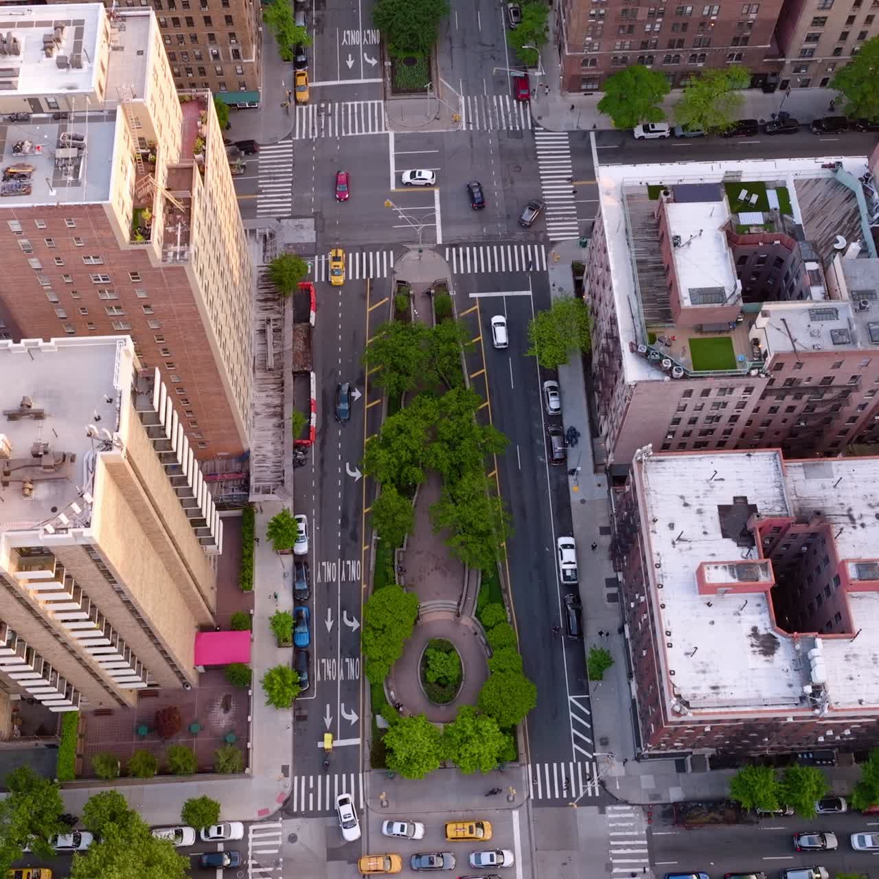 Various kinds of buildings in the district of New York. Busy streets with many cars going along. Aerial perspective
