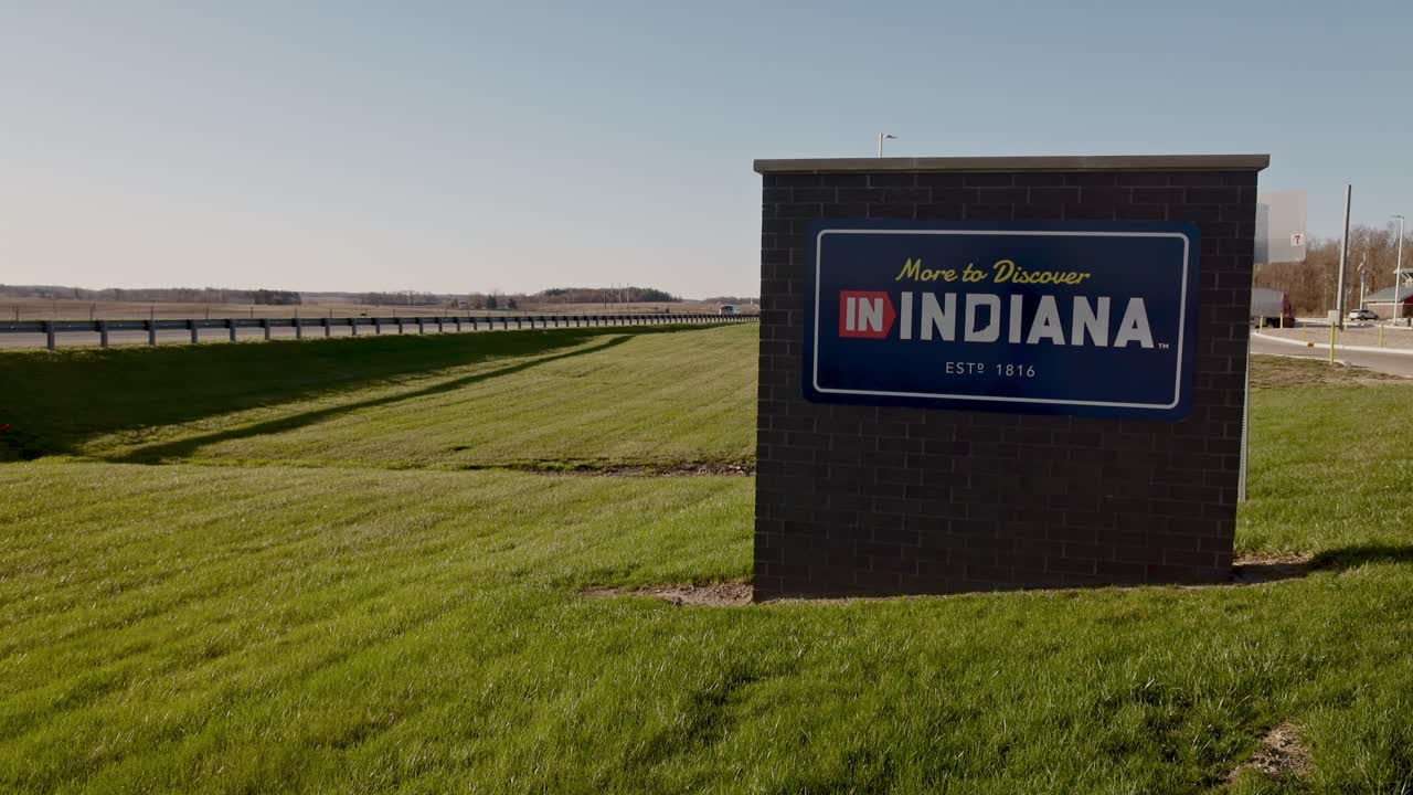 Indiana, More to Discover sign at a rest area along I69 in Indiana vehicles driving by and wide stable video