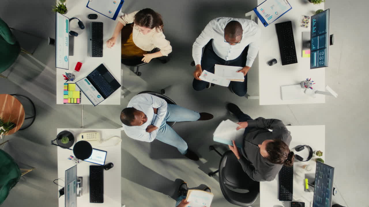Top down view zoom in of employees discussing targets and objectives
